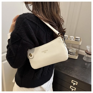 Detail of white lychee pattern shoulder bag with gold zipper and fashion bag logo