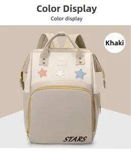 Detail view of the khaki and cream waterproof diaper backpack with star patch and wide handles