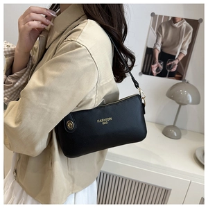 Detail showing high-quality black lychee texture leather on crossbody pillow bag