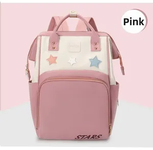 Front view of pink and beige diaper backpack with star patches and durable top handle