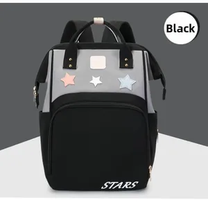 Detail of waterproof nylon mommy bag in black and grey with star patch and STARS print