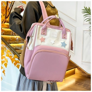 Lifestyle view of stylish color-block mommy backpack with star patches on the front pocket