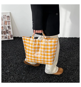 Fashionable yellow gingham tote bag featuring white handles and TOTE BAG lettering detail