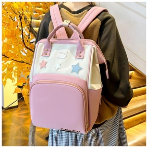 Close-up of pink and white star patch details on the water-resistant mommy backpack