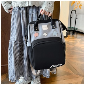 Detail view of the gray and black star patterned diaper backpack with stars embroidery