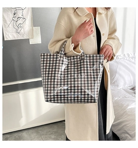 Detail of checkered tote bag with transparent waterproof layer and large TOTE BAG text print