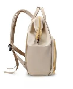 Detailed side view of beige and brown waterproof mommy backpack with functional side pockets