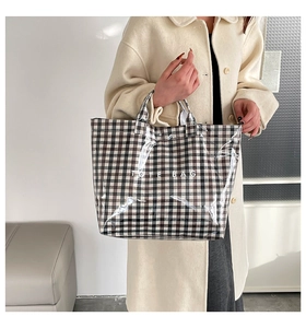 Close-up of black and white checkered tote bag with transparent PVC outer layer