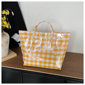 Yellow and white checkered waterproof canvas tote bag with bold TOTE BAG lettering print