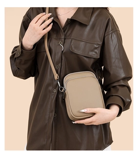 Close-up of khaki crossbody bag with litchi texture and adjustable shoulder strap