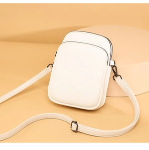 Detail of white litchi pattern mini crossbody bag with double zippers and metal hardware