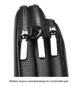 Detail of black pebbled leather bag with triple long-handle metal zippers for easy grip