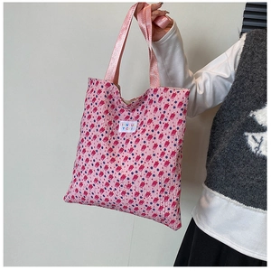 Detailed shot of pink tote bag with red popsicle print and textured crinkle fabric