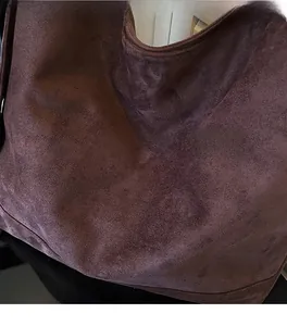 Close-up of the soft dark brown faux suede fabric with a textured finish on this tote bag