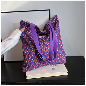Floral print purple tote bag with seersucker texture on desk for daily shopping use