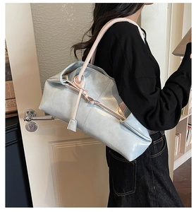 Détail du sac cabas bleu clair avec lanières beige et finition en cuir texturé