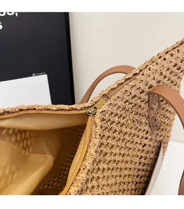 Close-up of the smooth golden zipper closure and inner lining of this straw tote bag