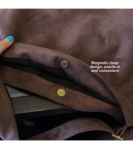 Close-up of magnetic buckle closure on large brown faux suede minimalist tote bag