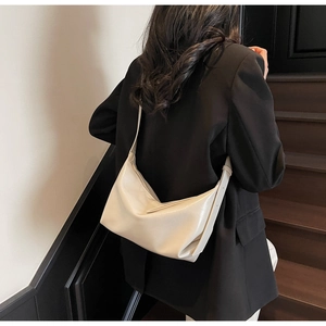 Detail shot of the cream white hobo bag showing the high-quality soft synthetic leather texture