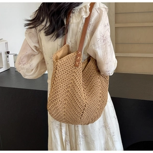 Detailed close-up showing the dense V-shape weave and dark brown leather straps on the tote