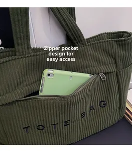 Détail du cabas en velours côtelé vert avec poche zippée pour ranger une tablette