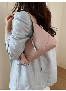 Pink lychee grain leather hobo bag with silver metal lock shown on female model