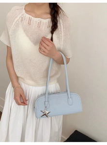 Light blue faux leather baguette bag featuring a silver starfish charm and slim shoulder strap