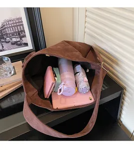 Detailed view of the spacious interior of the brown suede tote bag showing large capacity