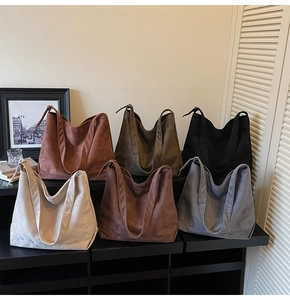 Detailed display of large matte tote bags in earth tones with wide shoulder straps
