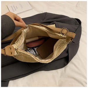 Interior view of straw shoulder bag showing large capacity for essentials and zip closure