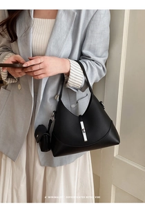 Detail of black leather dumpling bag with silver buckle and small matching pouch