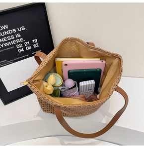 Top-down view of spacious woven straw tote bag interior showing capacity and leather handles
