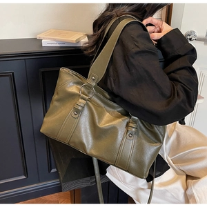 Olive green leather tote bag with vertical stripes and metallic ring buckle detail