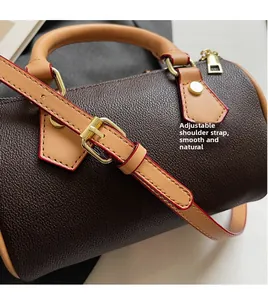 Detailed close-up of adjustable leather shoulder strap with gold metal buckle on handbag