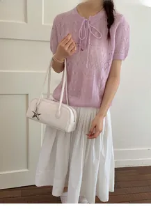 Chic white leather handbag for women featuring elegant star charm and slim handles