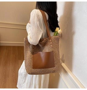 Detail of hand-woven straw tote bag with brown leather pocket and large capacity
