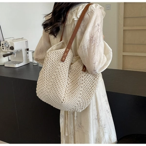 Detail of hand-woven cotton tote bag with premium brown leather straps and cross stitching