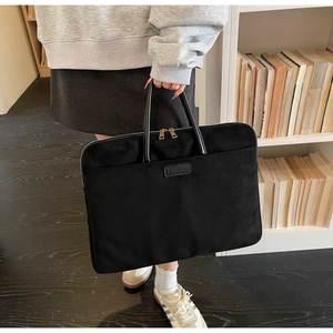 Detail of black large capacity laptop bag with gold zippers for 14 inch business commuting