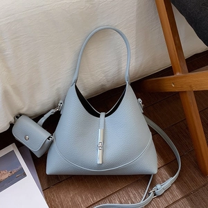 Chic light blue leather dumpling handbag with silver lock and adjustable shoulder strap