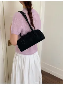 Minimalist black matte leather bowling bag with slim handles shown on a model