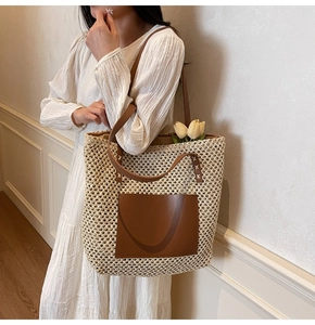 Detail of hand-woven straw tote bag with brown leather pocket and handle for beach style