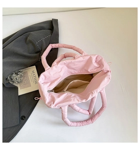 Top view of the pink quilted down tote bag showing internal space and zippered pocket