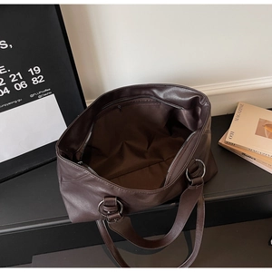 Macro detail of the spacious brown leather tote interior with a secure zipper pocket