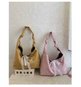 Polka dot canvas tote bags in mustard yellow and dusty pink with lace bow details