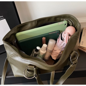 Spacious olive green soft leather tote bag showing interior capacity and daily essentials