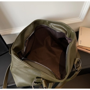 Top view of olive green tote bag interior showing dark brown lining and zipper pocket