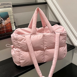 Pink quilted puffer tote bag with square stitching and adjustable shoulder strap
