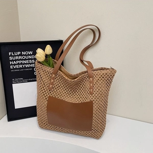Minimalist straw tote bag with brown faux leather pockets for seaside beach holidays