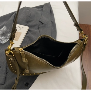 Detail view of olive green hobo bag featuring gold rivet accents and black fabric lining