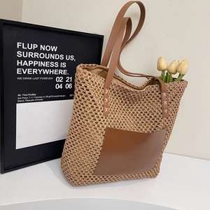 Minimalist straw tote bag with brown leather pocket and handles for beach vacations